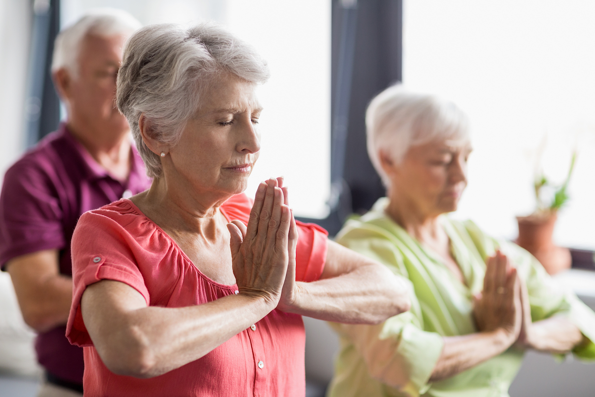 Seniors Meditating Through Yoga