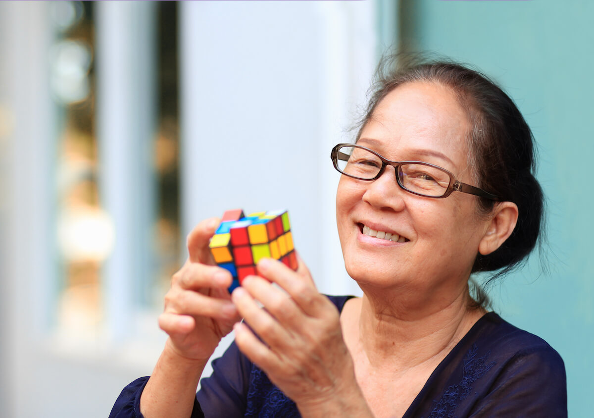 Older woman with a Rubik's cube.