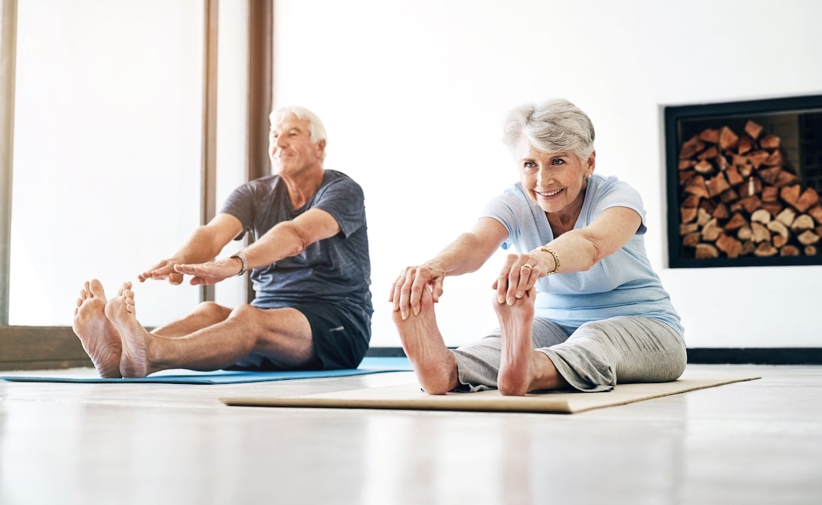 Couple of older adults doing pilates.